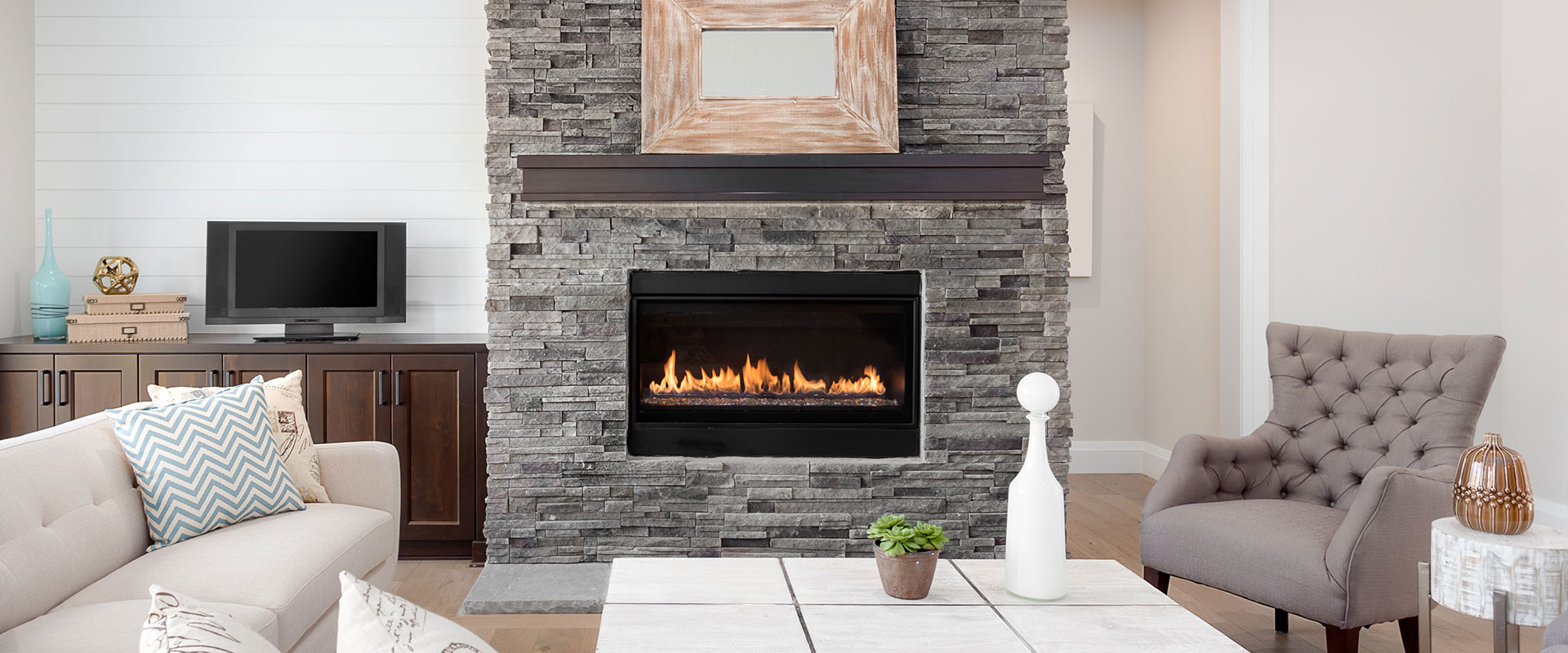a fire place sitting in a living room filled with furniture and a fireplace